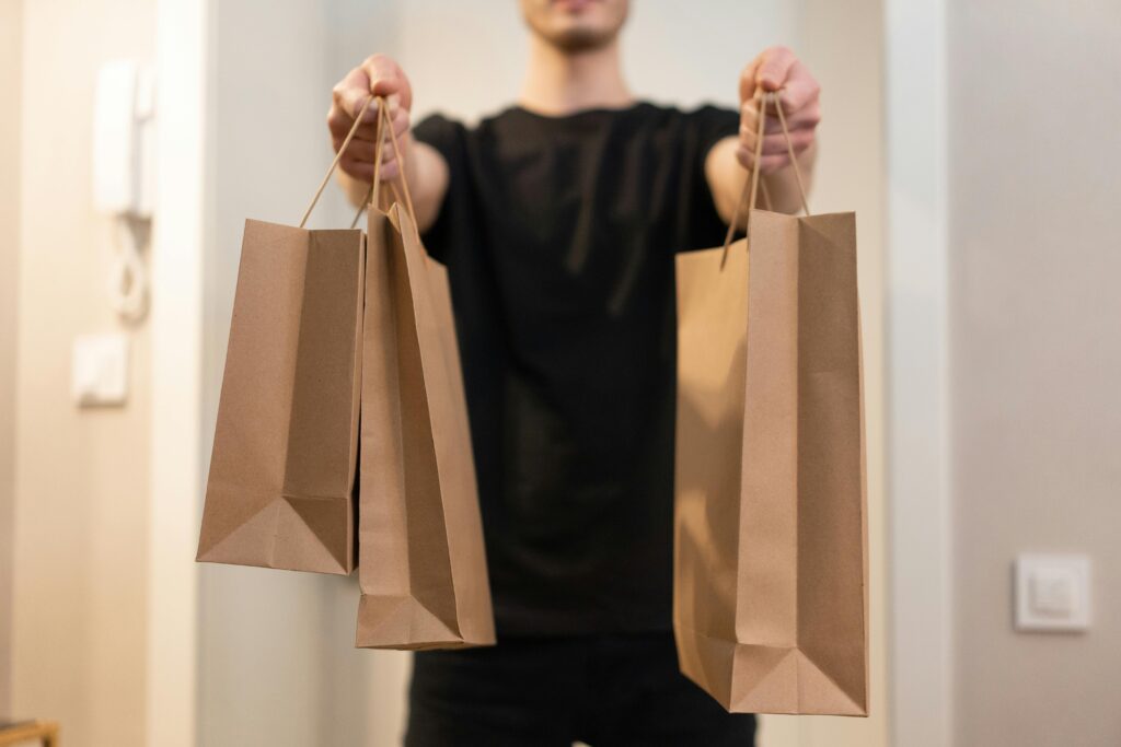 Photo of a Person Handing Paper Bags